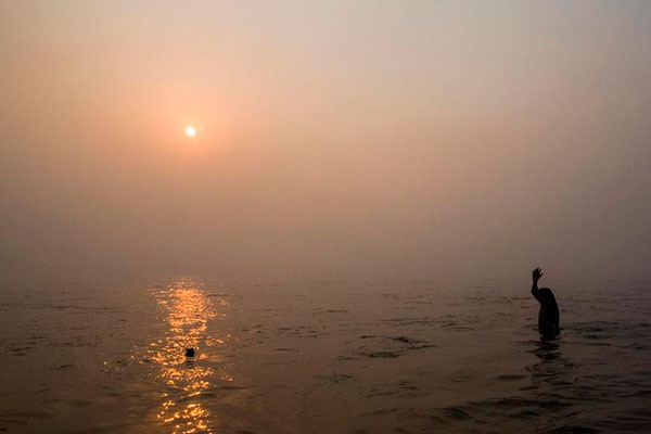 Indian holy man performing his morning ablutions in the Sacred Ganges